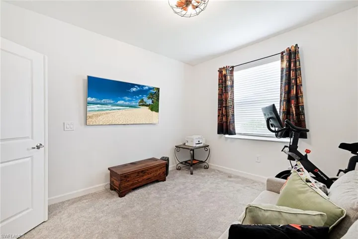 Exercise room with carpet and baseboards