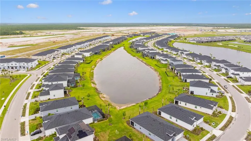 Aerial perspective of suburban area featuring a nearby body of water