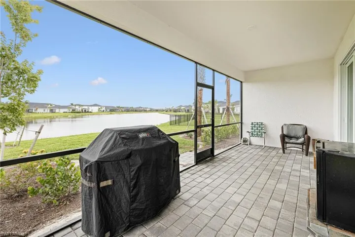 Sunroom / solarium featuring a water view and a residential view