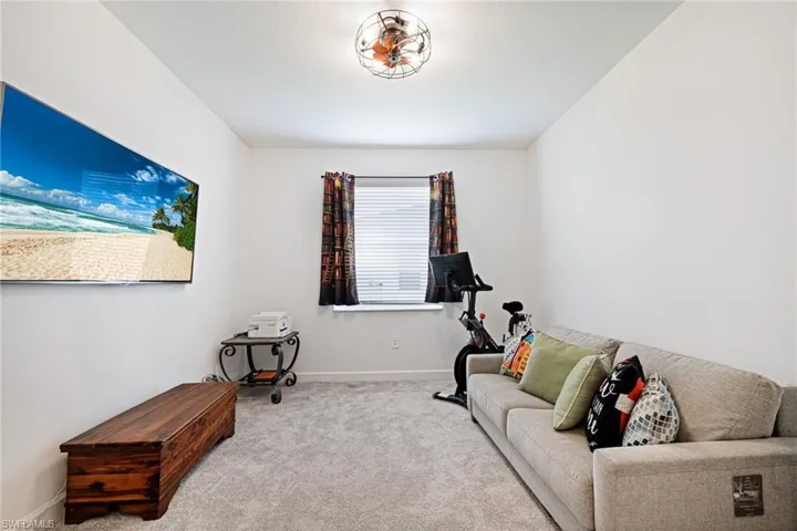 Exercise area featuring carpet floors and baseboards
