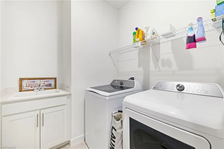 Washroom featuring washing machine and dryer and cabinet space