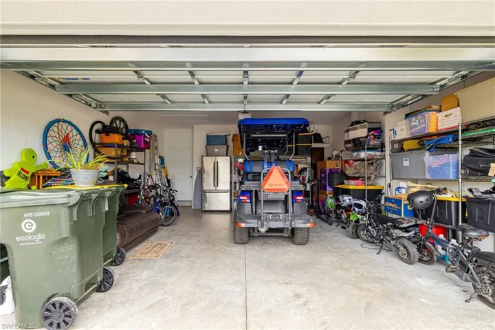 Garage featuring freestanding refrigerator