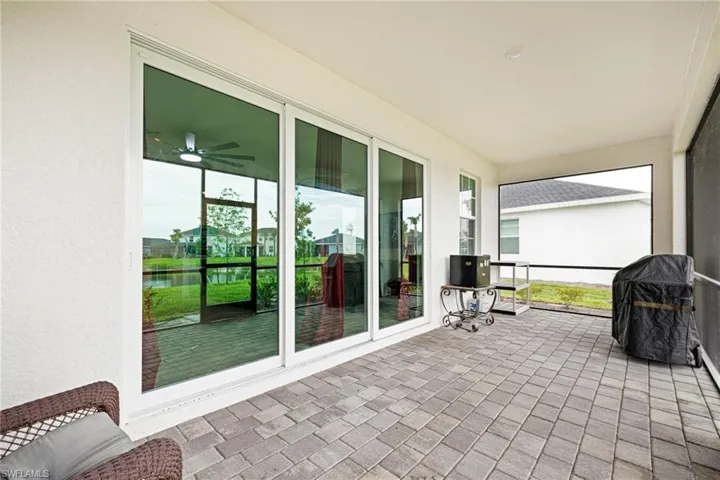 Sunroom / solarium with a water view and a ceiling fan