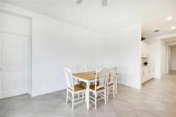 Dining area featuring light tile patterned floors, recessed lighting, and a ceiling fan