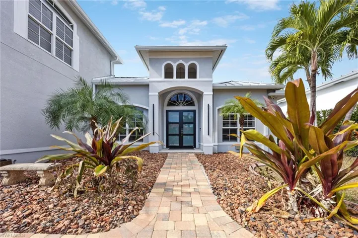 Entrance to property featuring a standing seam roof, stucco siding, and french doors
