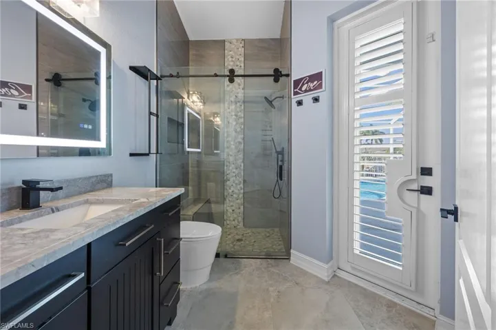 Full bathroom with a shower stall and vanity