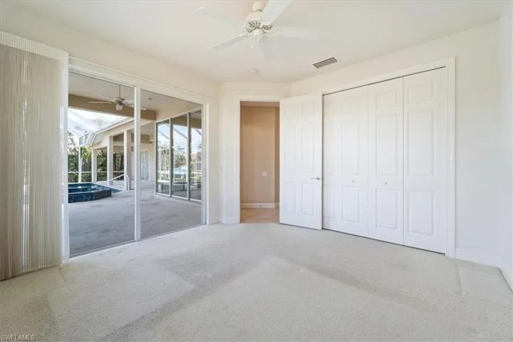 Unfurnished bedroom featuring ceiling fan, access to exterior, a closet, and carpet