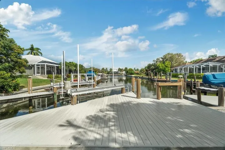 View of dock featuring a water view and a lanai