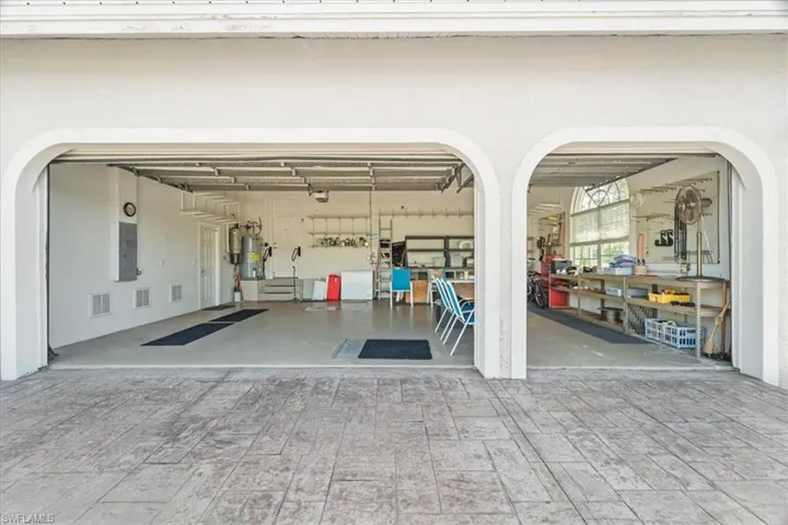 Garage with strapped water heater and electric panel