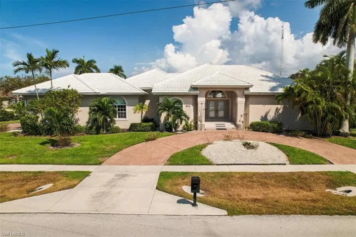 Mediterranean / spanish-style house featuring a front yard