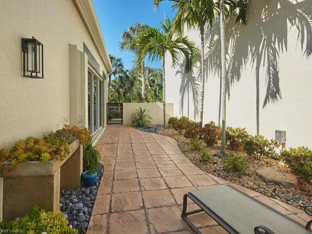 Side entry from lanai to walking path and river beyond.
