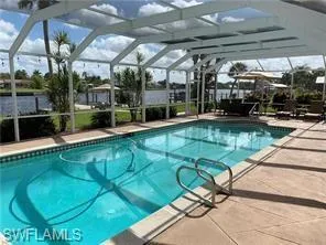 Swimming pool with a lanai and a patio area