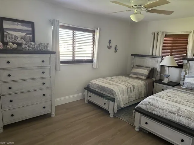 Bedroom featuring dark wood-style floors and a ceiling fan