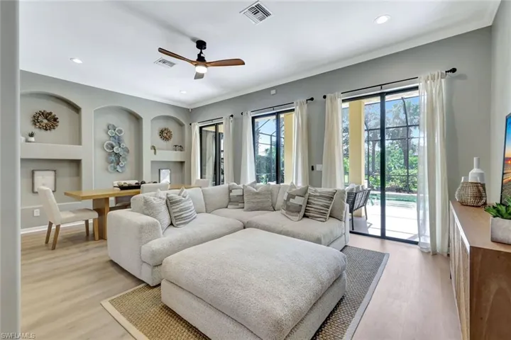 Living area with ornamental molding, light wood finished floors, a ceiling fan, and recessed lighting