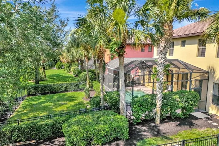 Fenced backyard featuring an outdoor pool and lanai