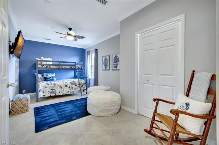 Bedroom featuring ornamental molding and ceiling fan