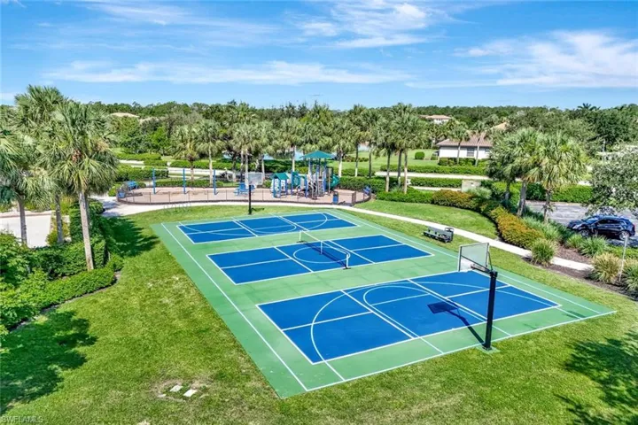 View of sport court featuring community basketball court, a lawn, and a tennis court