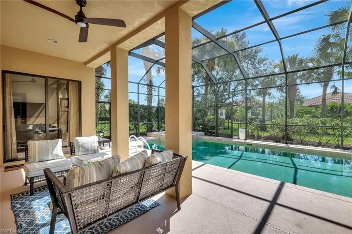 Swimming pool featuring a patio, outdoor lounge area, a ceiling fan, and a lanai