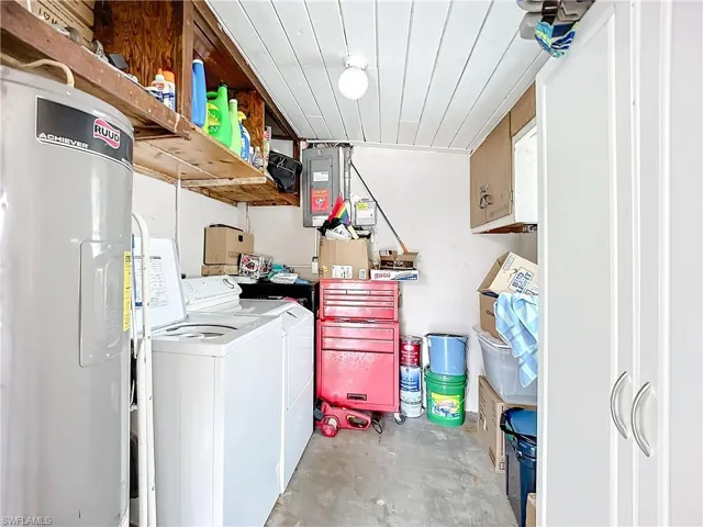 Laundry area featuring washer and dryer, wooden ceiling, and electric water heater