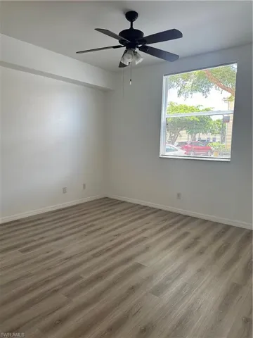 Spare room with hardwood / wood-style floors and ceiling fan