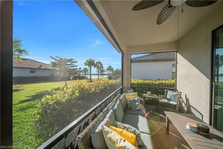Balcony with ceiling fan, an outdoor hangout area, and a water view