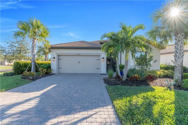 Mediterranean / spanish-style home featuring decorative driveway, an attached garage, and stucco siding