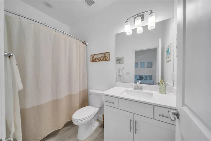 Full bath with vanity, connected bathroom, and curtained shower