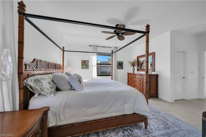 master bedroom featuring ceiling fan and baseboards