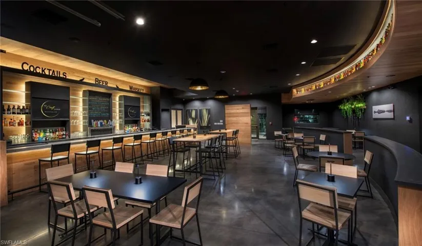 Dining space with finished concrete flooring and recessed lighting