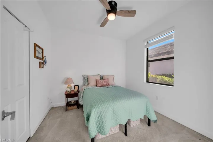 Bedroom 3 with ceiling fan and carpet