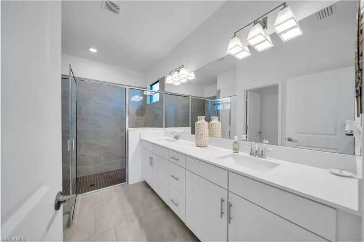 Bathroom with a shower stall and double vanity