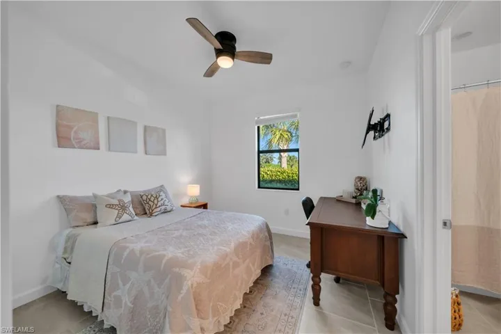 Bedroom 2 with ceiling fan and light tile patterned floors