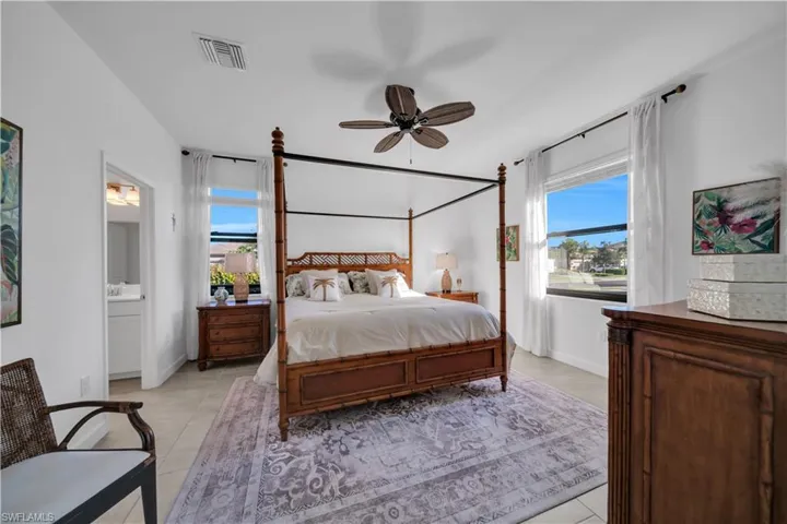 Master Bedroom with ceiling fan, ensuite bathroom, and light tile patterned floors