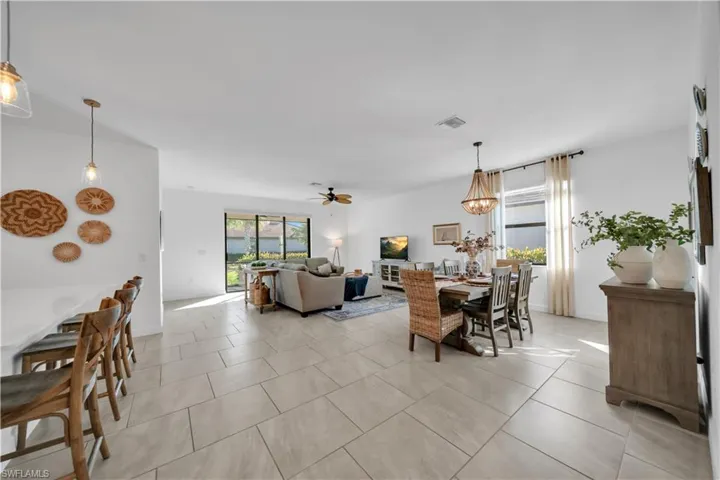 Dining space featuring a ceiling fan and light tile patterned floors