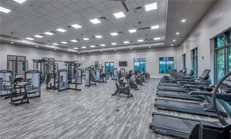 Exercise room with a high ceiling and a paneled ceiling