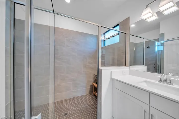 Bathroom featuring vanity and a stall shower