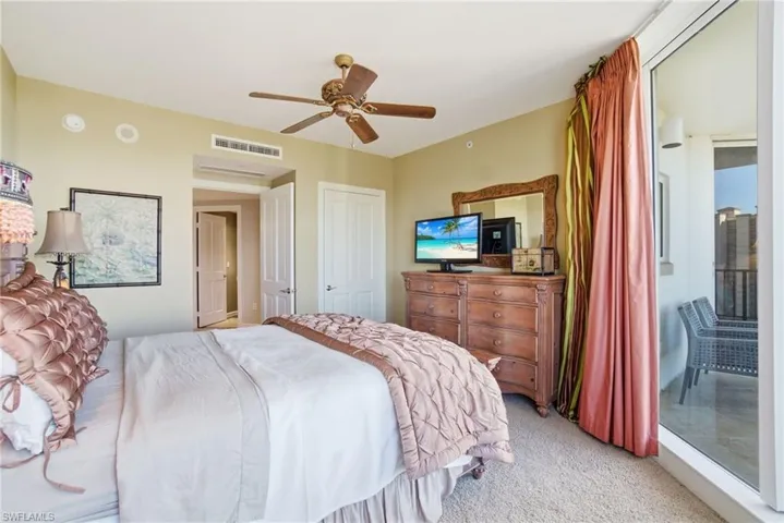 Bedroom with light colored carpet, a ceiling fan, access to outside, and a closet