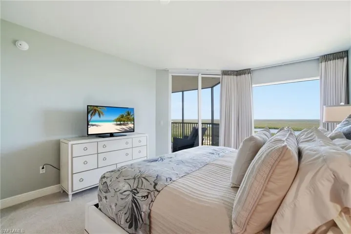 Bedroom with access to exterior and carpet flooring