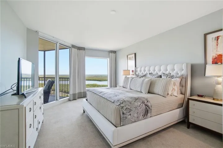 Bedroom with light colored carpet and access to outside