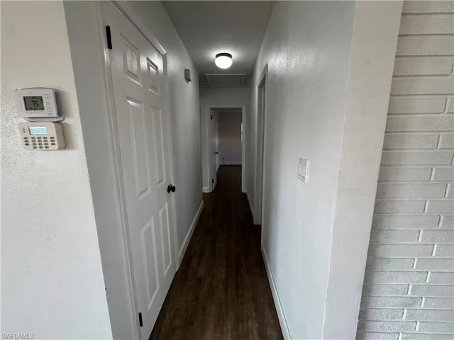 Bathroom featuring a sink, toilet, tile walls, wainscoting, and curtained shower