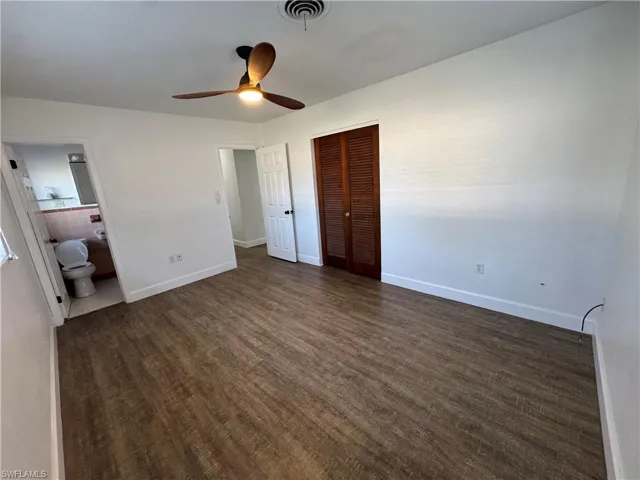 Full bathroom featuring tile patterned floors, toilet, a sink, tub / shower combination, and tile walls