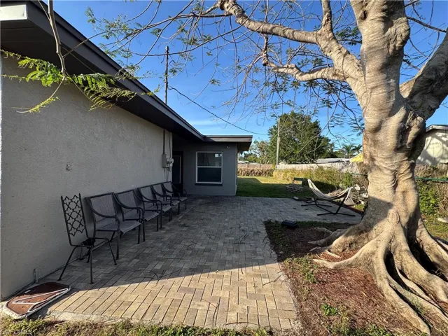 View of home's exterior with stucco siding and fence