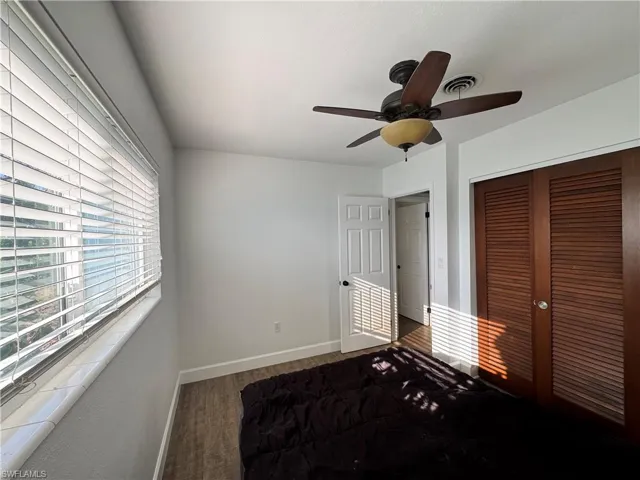 Hallway with baseboards and dark wood-style floors