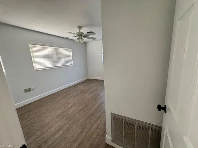 Unfurnished bedroom featuring baseboards, visible vents, wood finished floors, a closet, and ceiling fan