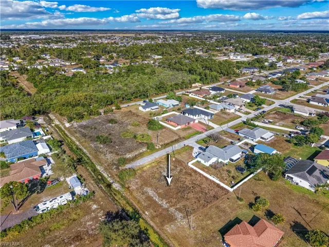 Aerial view of property's location with nearby suburban area