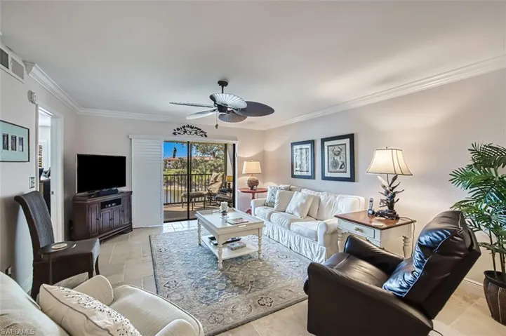 Living room with crown molding and ceiling fan