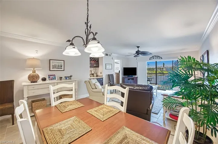 Dining space with crown molding and ceiling fan