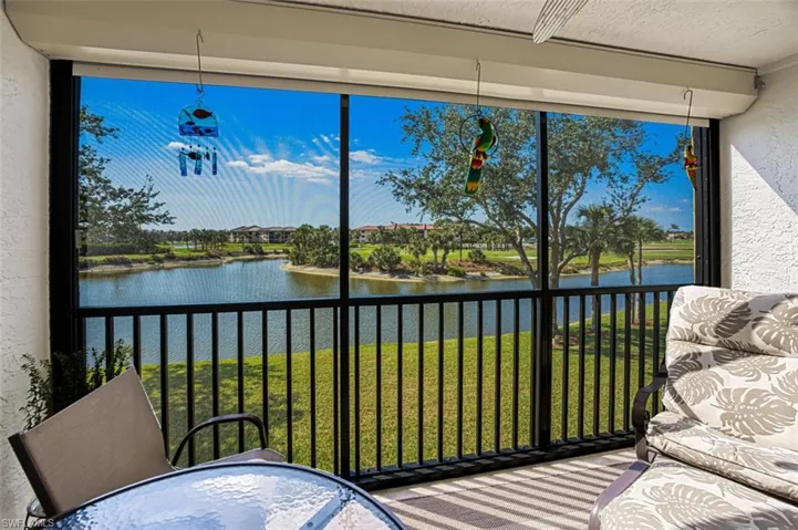 Sunroom with a water view and a healthy amount of sunlight