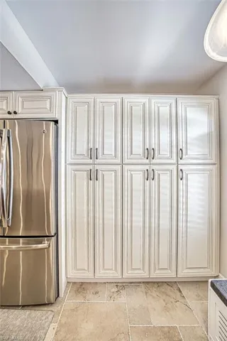 Kitchen with stainless steel refrigerator