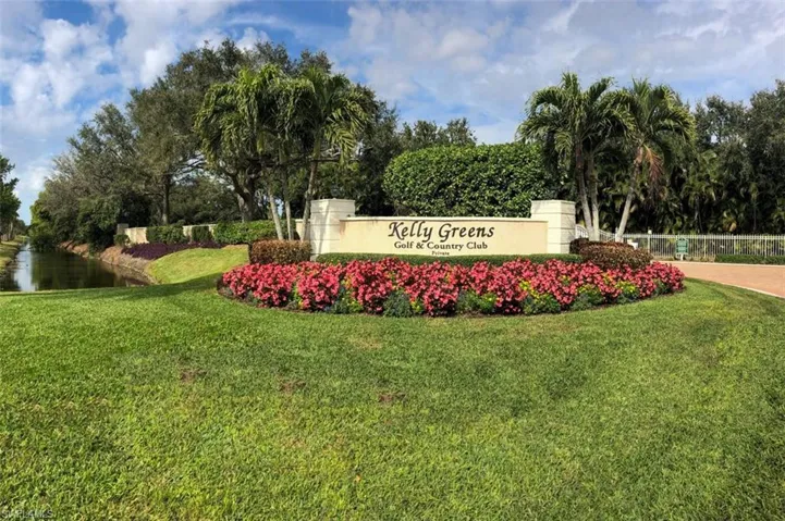 Community sign featuring a water view and a yard